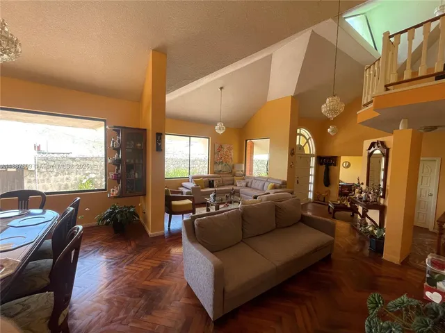 a view of workspace with wooden floor windows