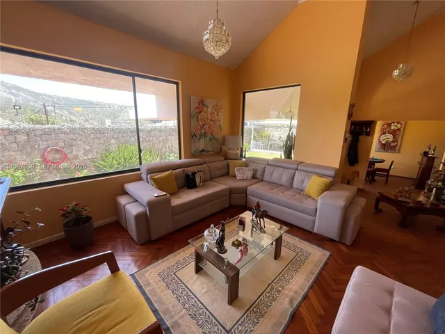 a view of a room with furniture and a window