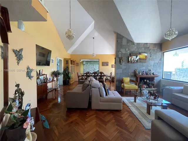 a kitchen with stainless steel appliances granite countertop a stove a refrigerator a kitchen island a sink a stove a dining table and chairs