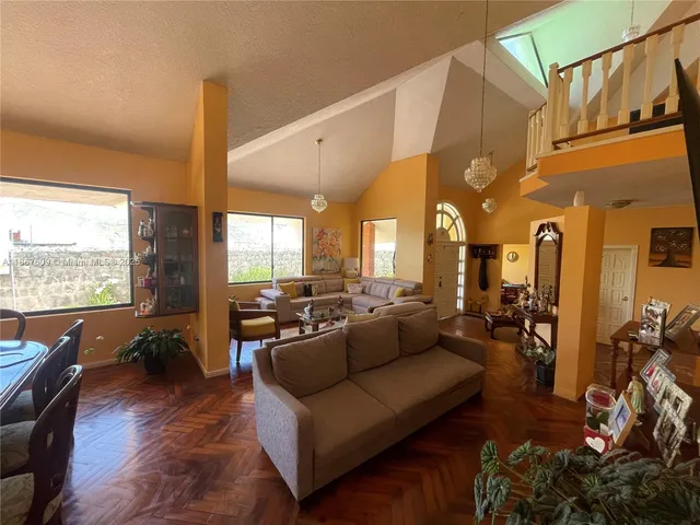 a kitchen with granite countertop white cabinets and a stove