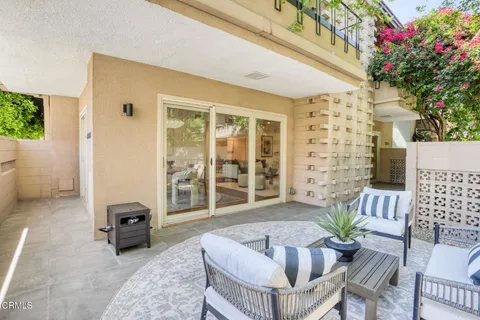 a view of a patio with a chairs and table in a patio