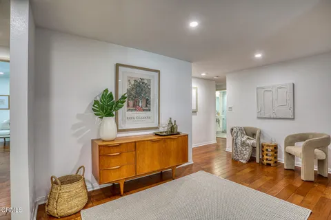 a living room with furniture flowerpot and wooden floor