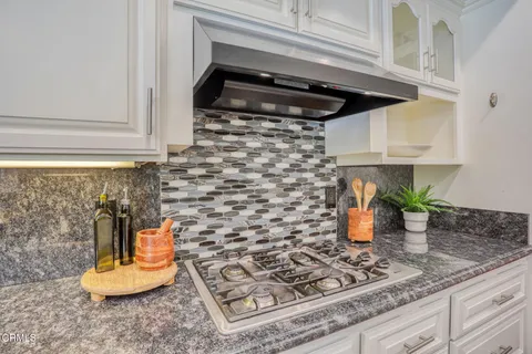 a kitchen with a stove and cabinets