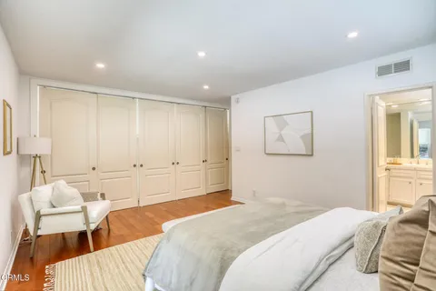 a bedroom with a bed and a couch