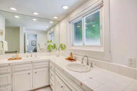 a bathroom with a double vanity sink and mirror