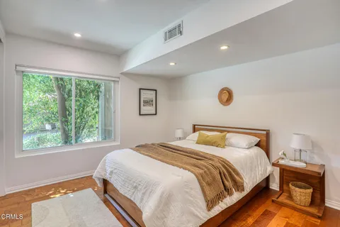 a bedroom with a bed and a large window