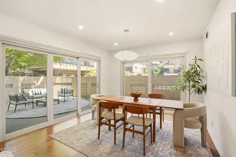 a view of a dining room with furniture large windows and wooden floor