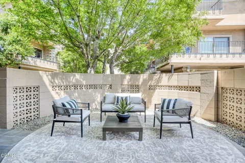 a view of a patio with table and chairs and potted plants