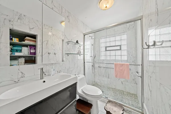 a bathroom with a sink toilet and shower