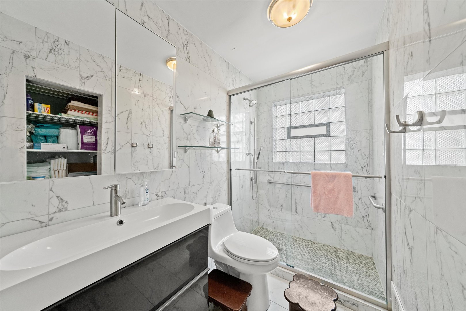 8819 North Wisner Street, Unit 1 Niles, IL 60714 - Photo 12 of 21 a bathroom with a sink toilet and shower