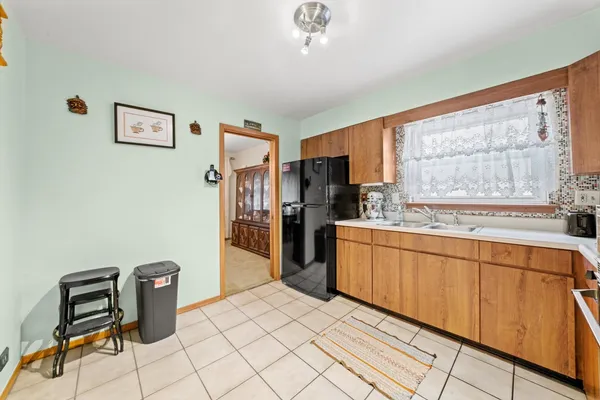 a kitchen with stainless steel appliances kitchen island granite countertop a refrigerator and a stove top oven