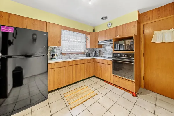 a kitchen with stainless steel appliances a refrigerator sink and cabinets