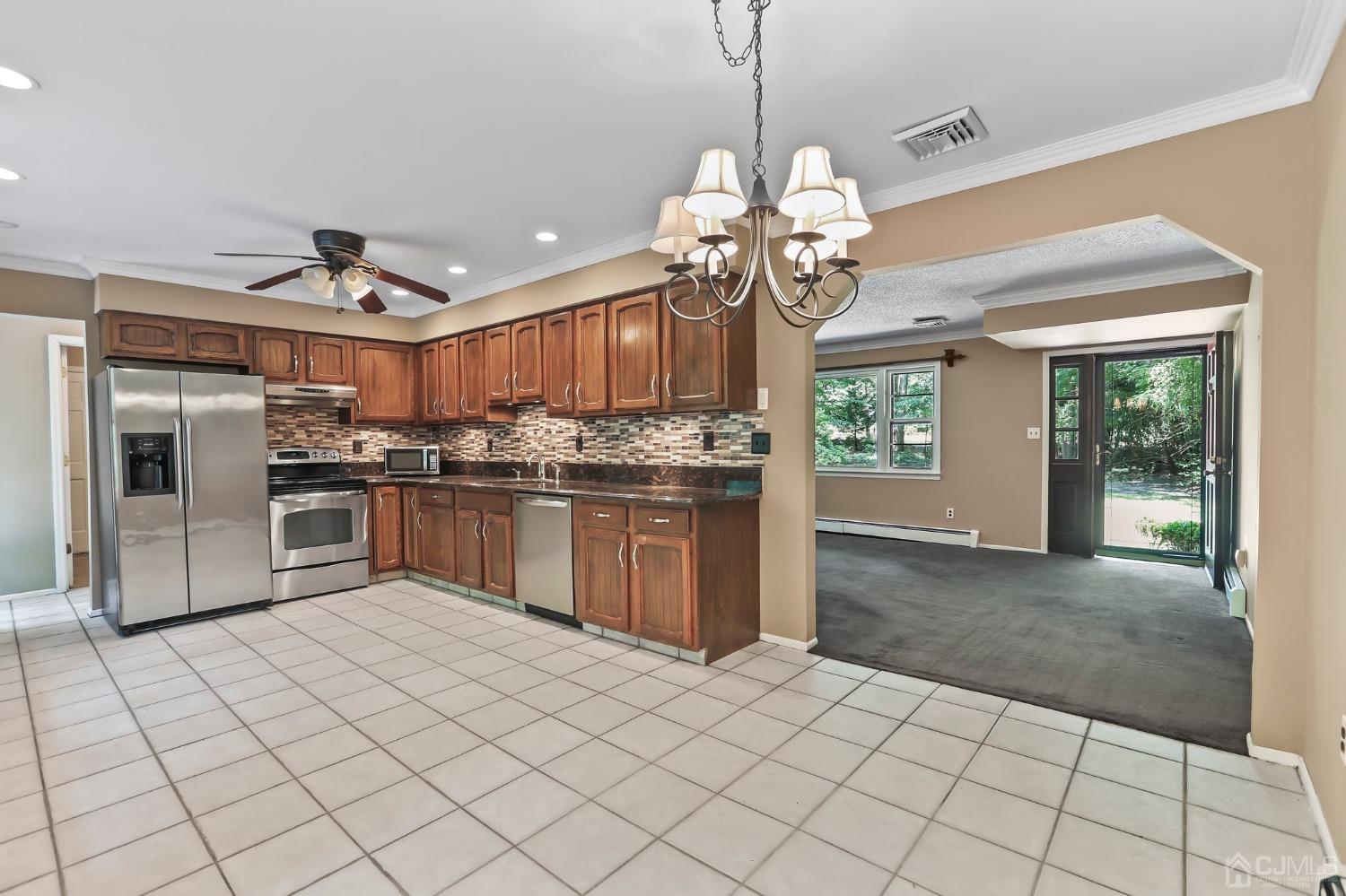 111 Old Forge Road Monroe Township, NJ 08831 - Photo 11 of 39 a kitchen with stainless steel appliances granite countertop a stove sink and refrigerator
