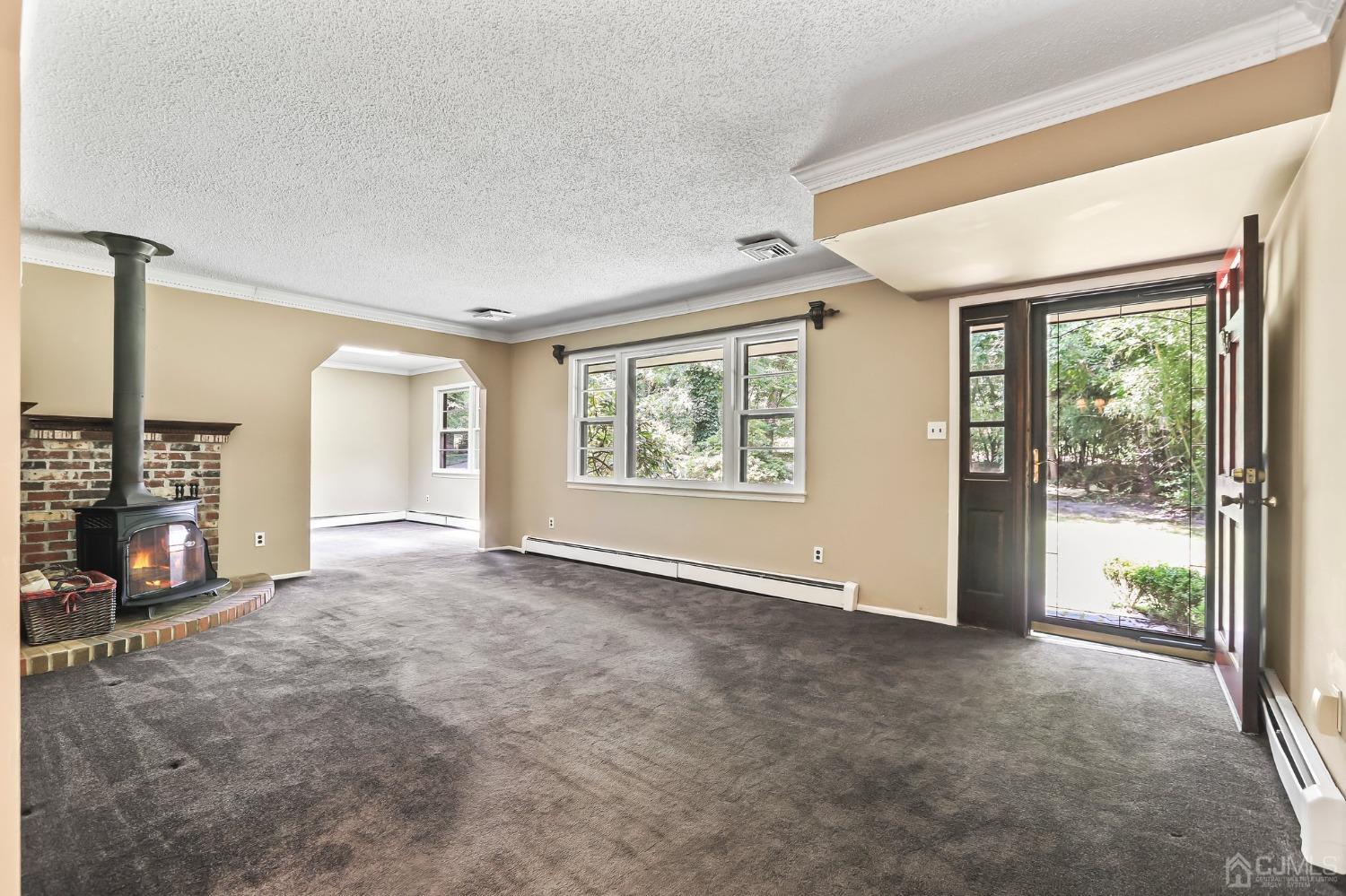 111 Old Forge Road Monroe Township, NJ 08831 - Photo 2 of 39 an empty room with windows and fireplace