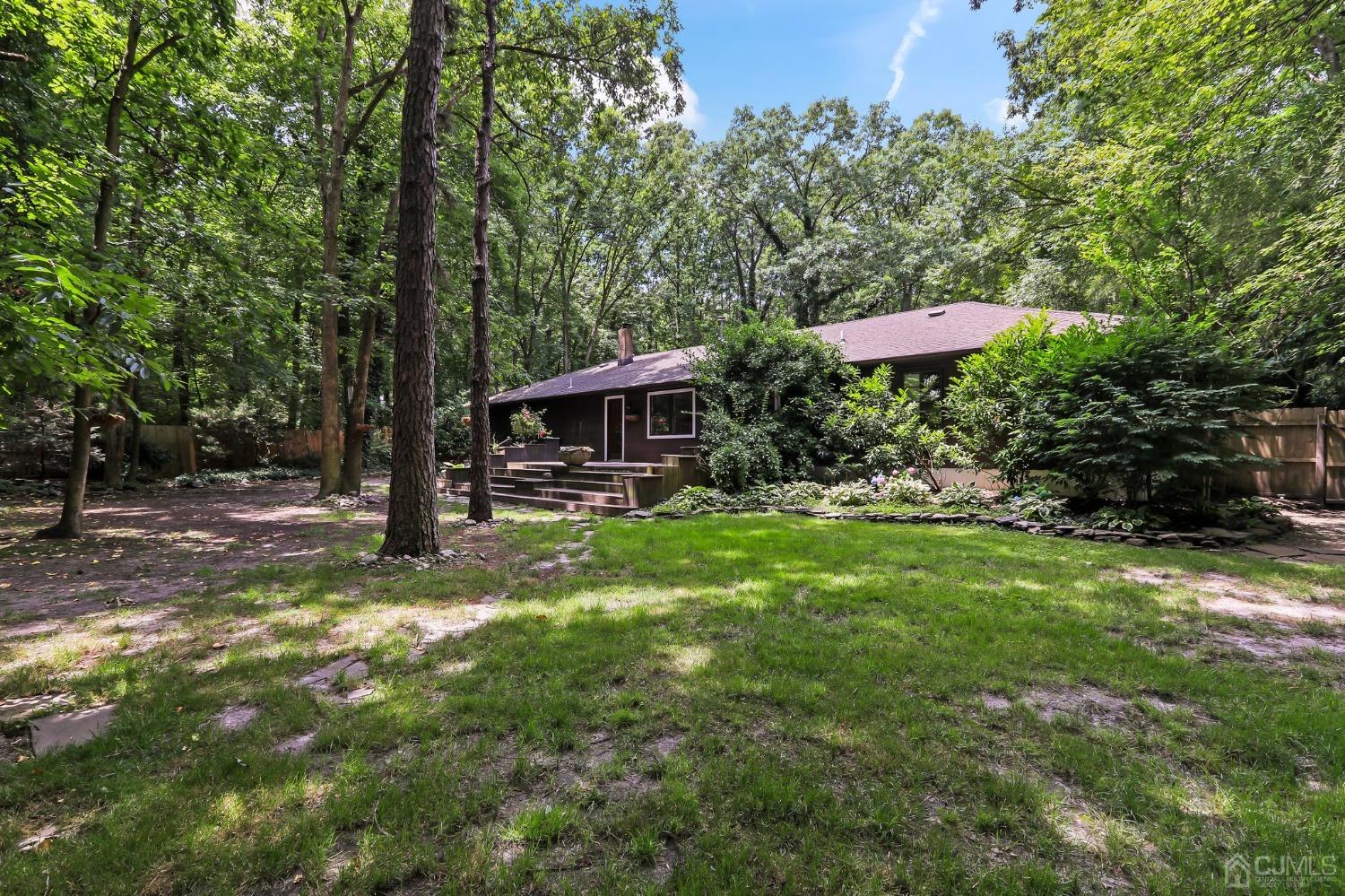 111 Old Forge Road Monroe Township, NJ 08831 - Photo 29 of 39 a view of a house with backyard fountain and sitting area