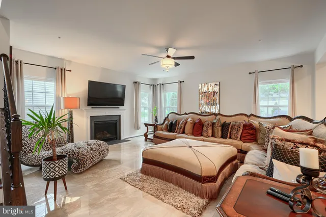 a kitchen with stainless steel appliances kitchen island granite countertop a table and chairs in it