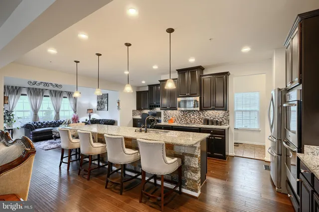 a living room with furniture a large window and a table