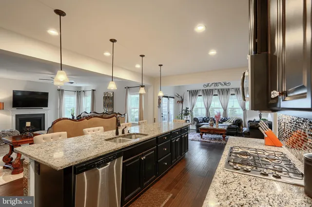 a living room with furniture a rug and a window
