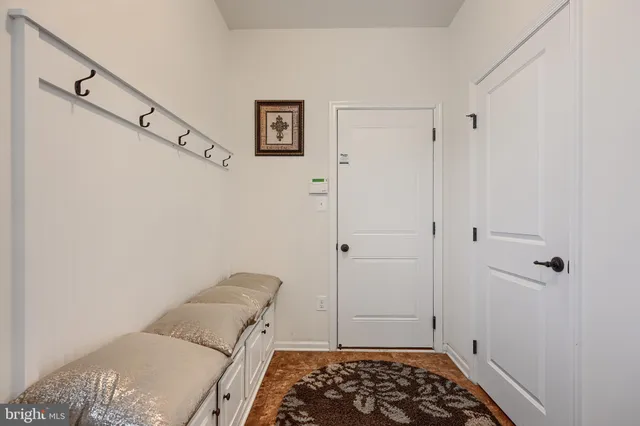 a bedroom with a bed a large window and walk in closet