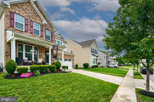 a living room with furniture and a book shelf