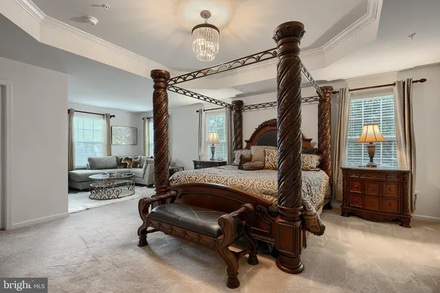 a bedroom with a bed and a flat tv screen on dresser