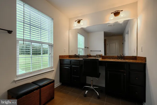 a living room with furniture a chandelier and kitchen view