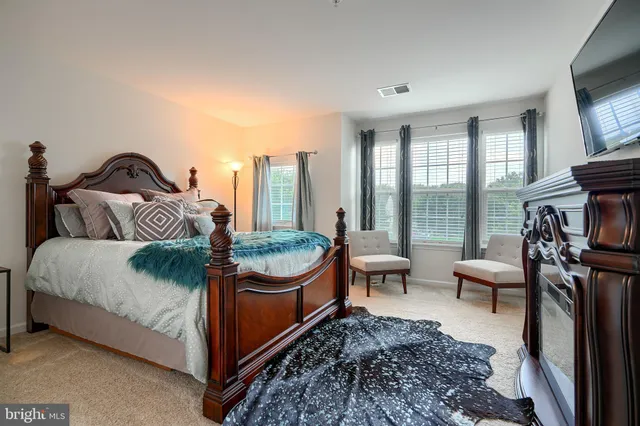 a living room with furniture a piano and a flat screen tv