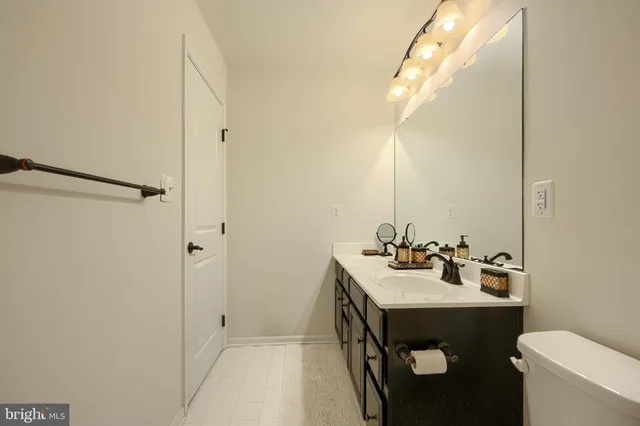 a front view of a house with a yard and green space