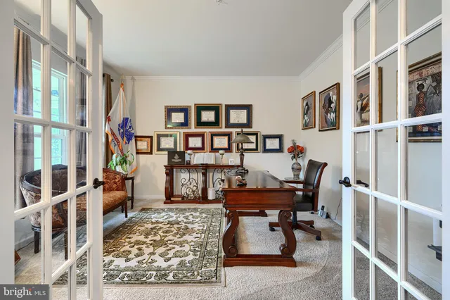 a living room with furniture kitchen view and a flat screen tv
