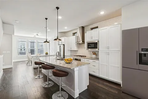 a kitchen with wooden cabinets and stainless steel appliances