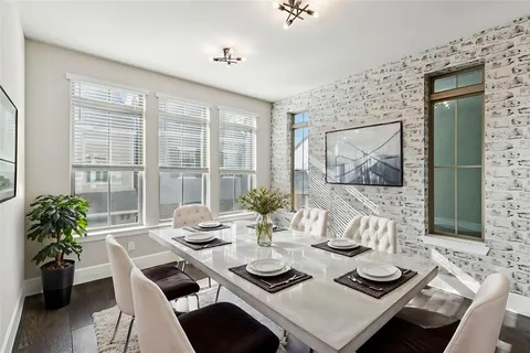 a view of a dining room with furniture large windows and wooden floor