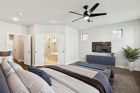 a bedroom with a bed and a television