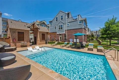a view of a house with swimming pool and sitting area