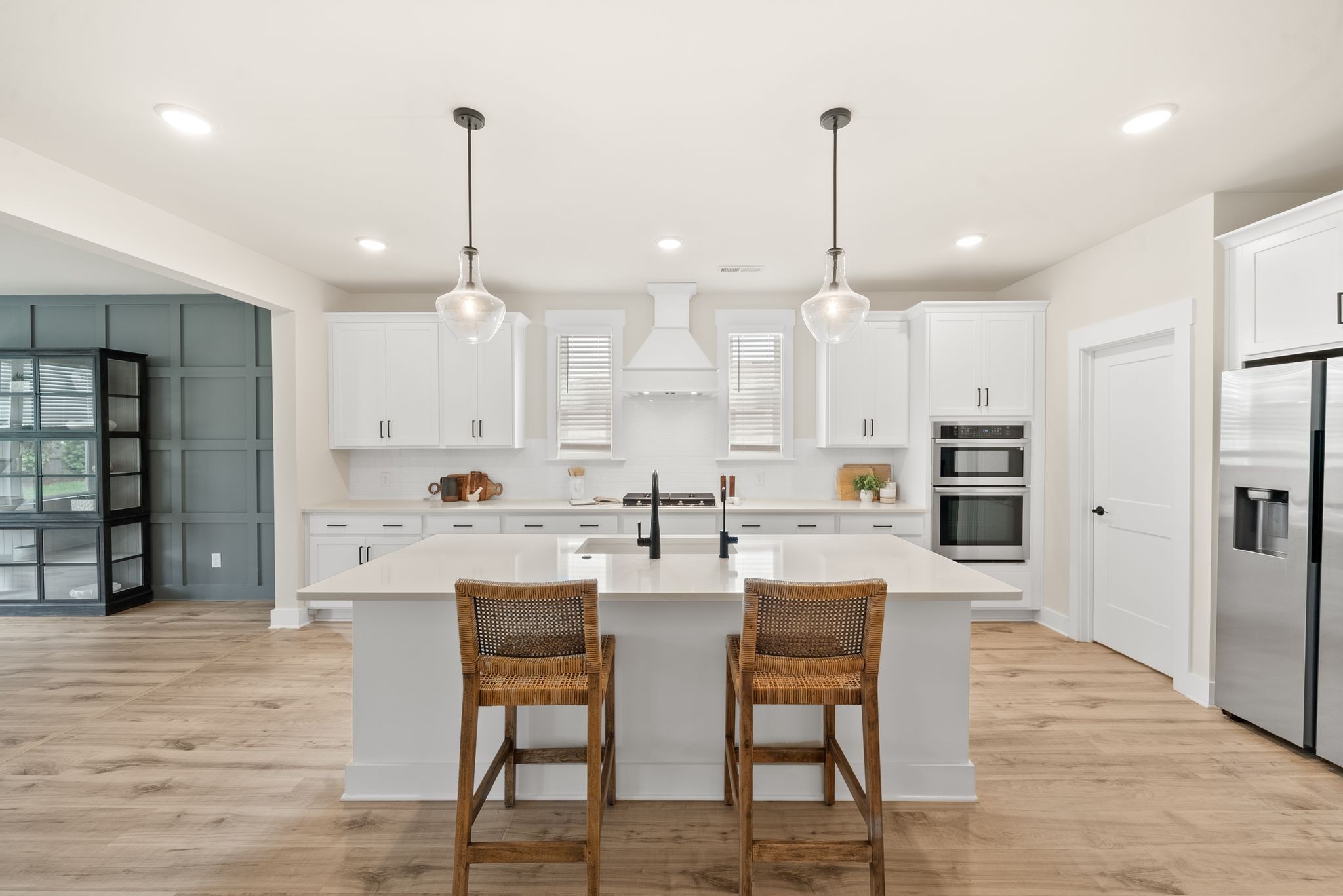 4043 John Marsh Road Spring Hill, TN 37174 - Photo 25 of 56 a kitchen with stainless steel appliances kitchen island granite countertop a dining table chairs and white cabinets