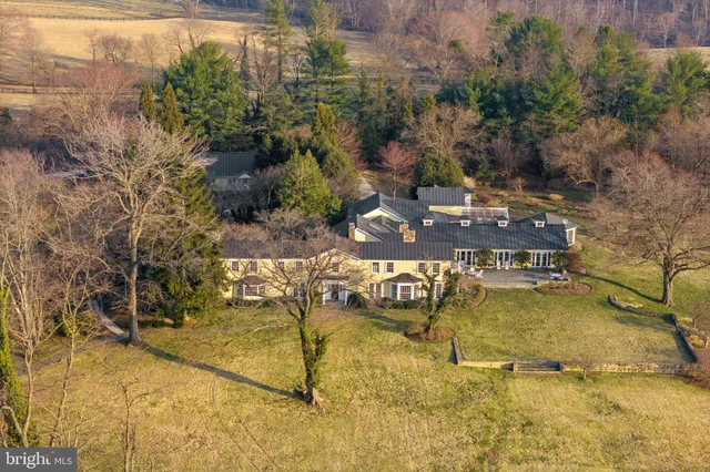 a living room with furniture a rug and a fireplace