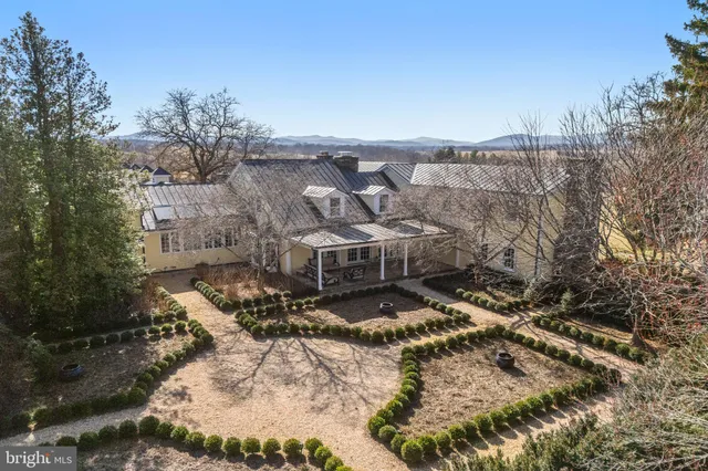 a view of a room with a large window and wooden floor