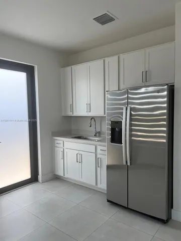 a kitchen with stainless steel appliances granite countertop a refrigerator and a stove