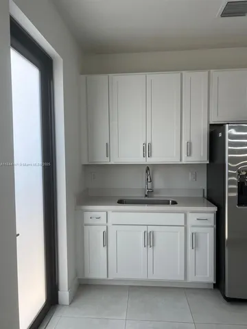 a kitchen with white cabinets