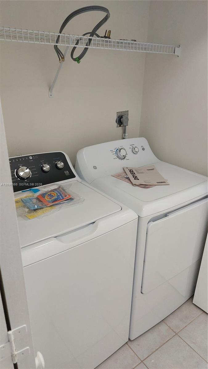7083 Southwest 158th Court Miami, FL 33193 - Photo 5 of 22 a utility room with dryer and washer