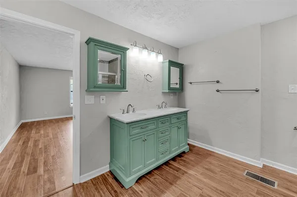 a bathroom with a double vanity sink and mirror