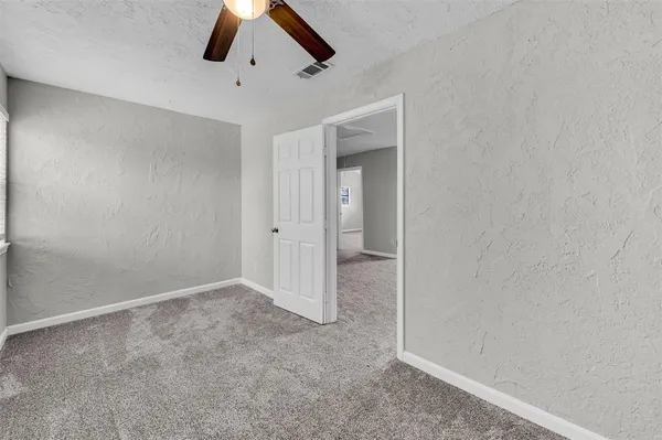 an empty room with a ceiling fan