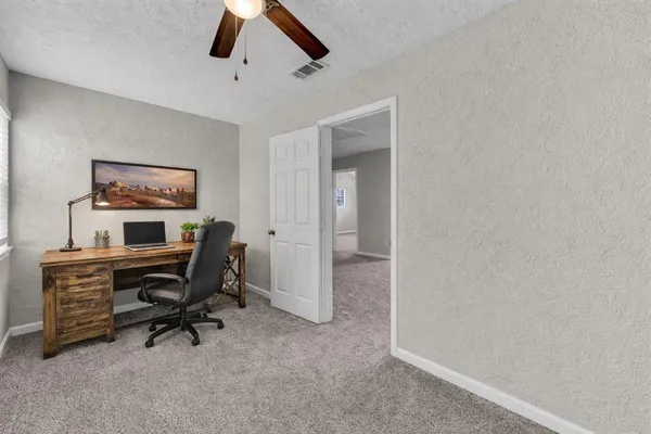 a view of a workspace with furniture