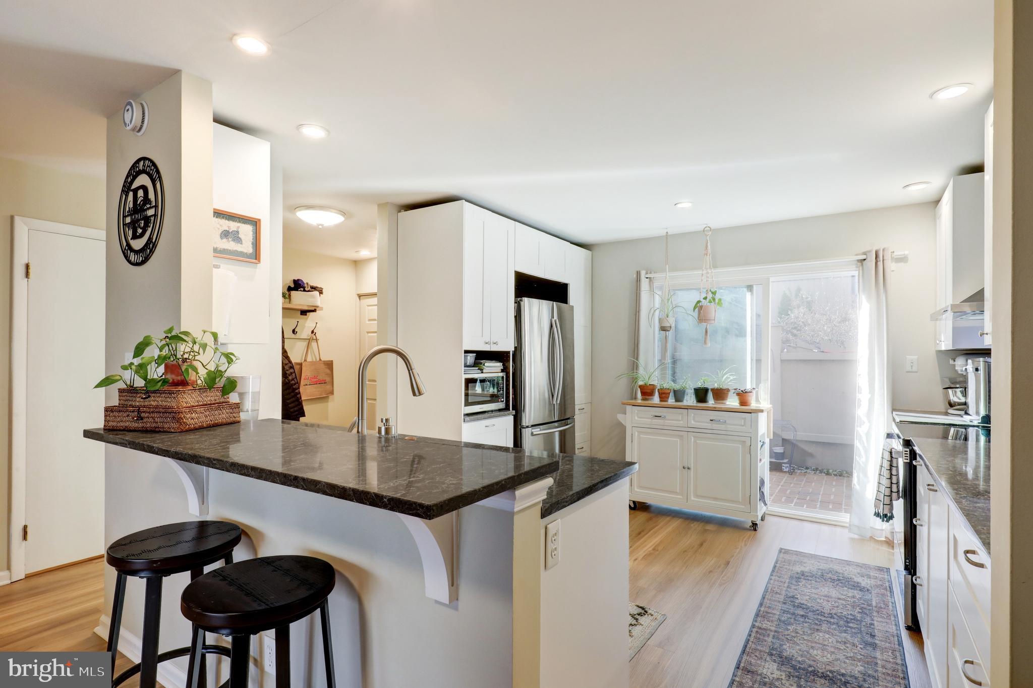 165 Oakmont Court Reading, PA 19607 - Photo 12 of 40 a kitchen with granite countertop a table and chairs in it