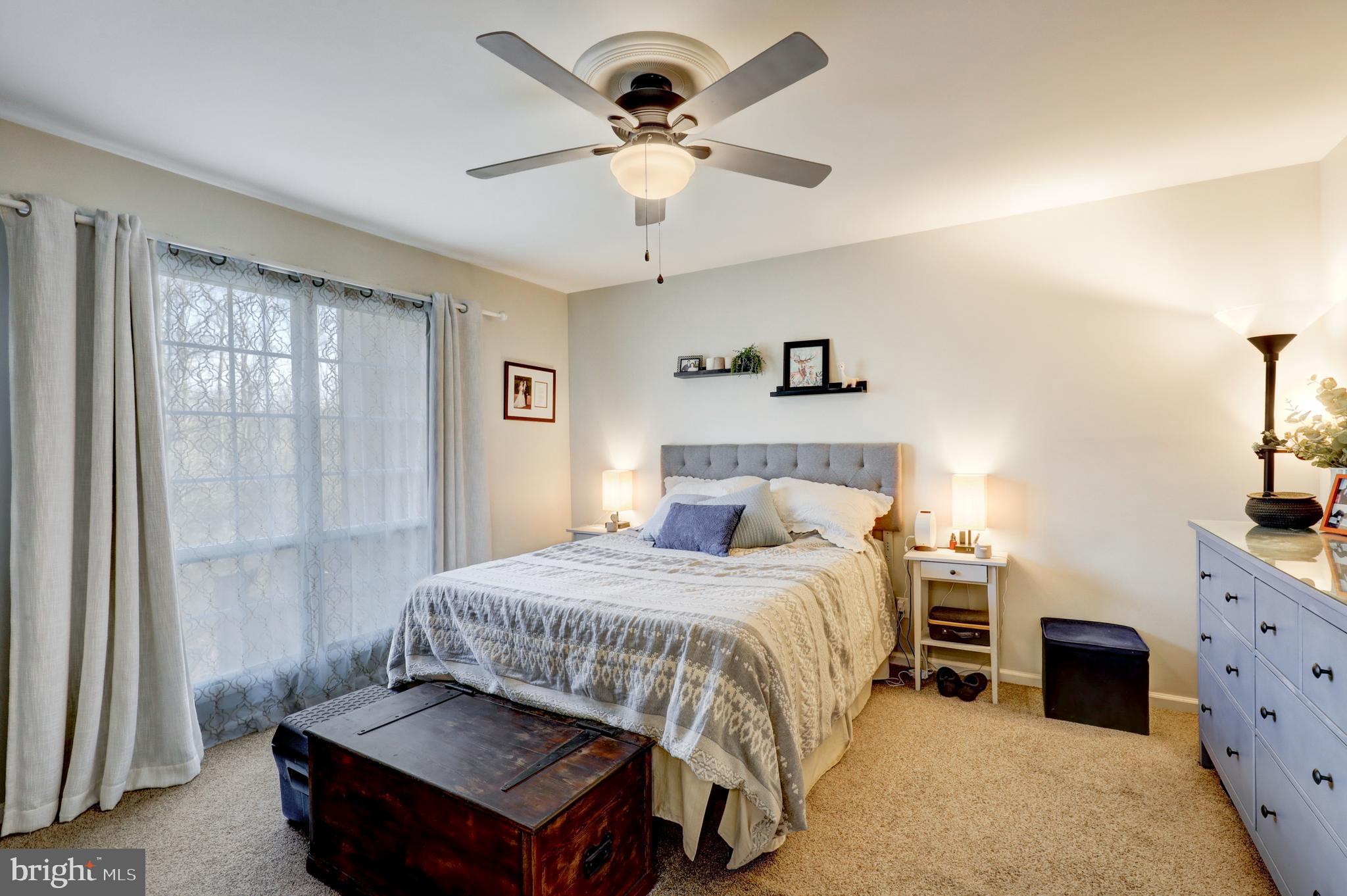 165 Oakmont Court Reading, PA 19607 - Photo 24 of 40 a bedroom with a bed and a chandelier