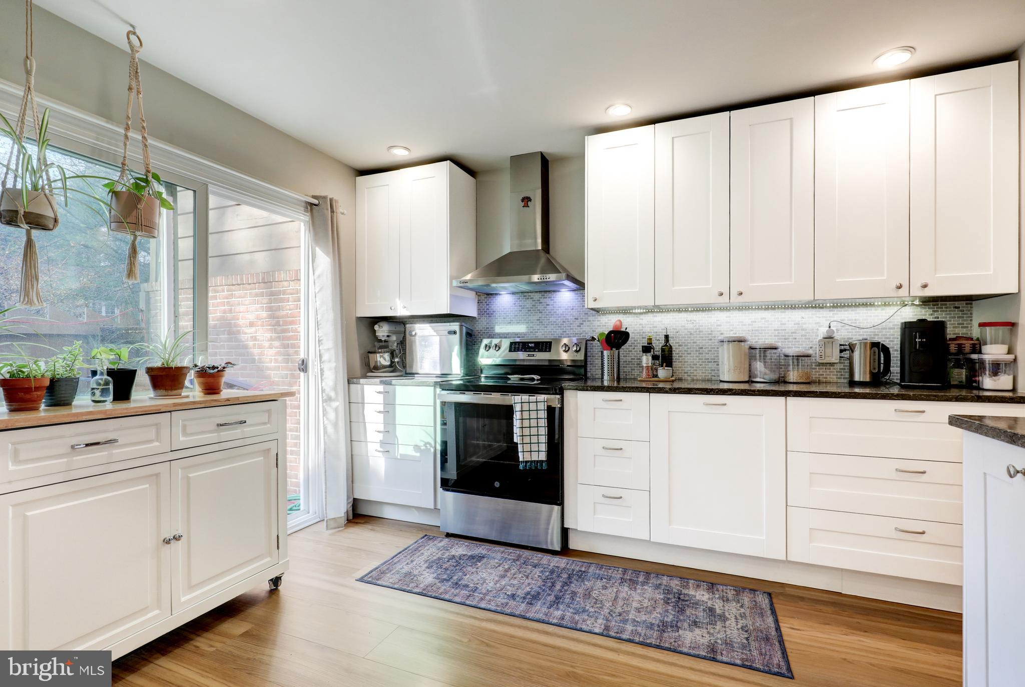 165 Oakmont Court Reading, PA 19607 - Photo 8 of 40 a kitchen with granite countertop white cabinets and white appliances