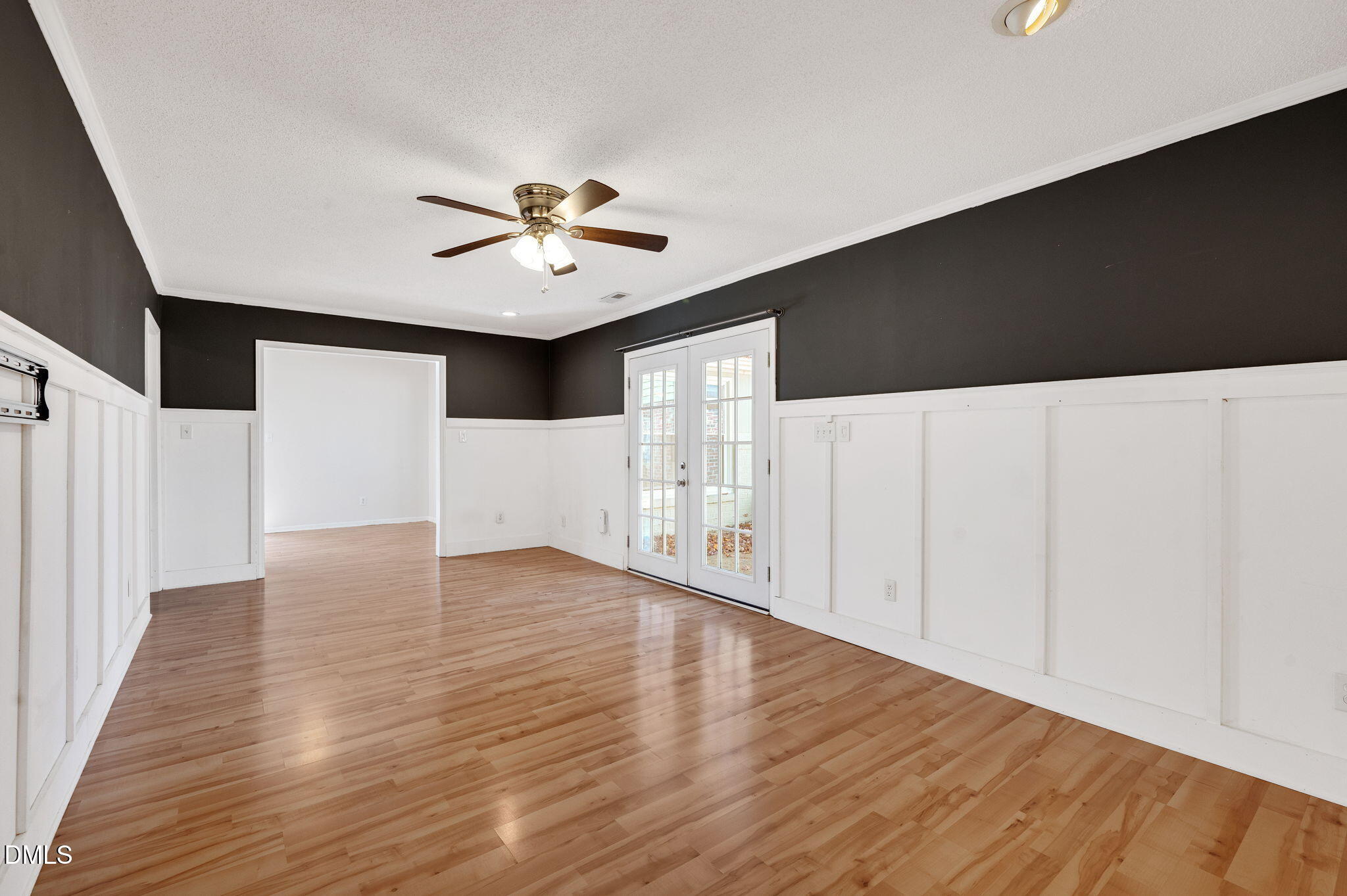 102 Castill Place Garner, NC 27529 - Photo 14 of 37 a view of an empty room with wooden floor and a ceiling fan