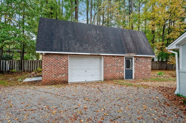 a backyard of house with a yard and garage