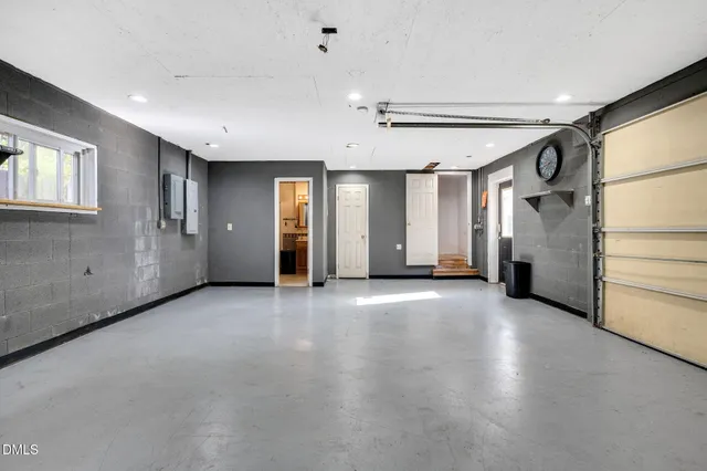 an empty room with windows and closet