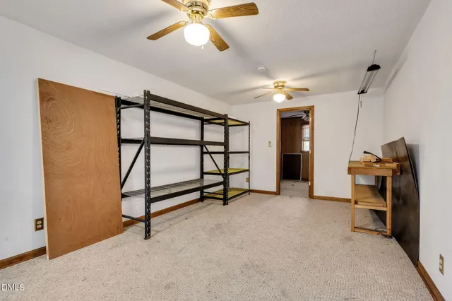 a view of a livingroom with furniture and a ceiling fan