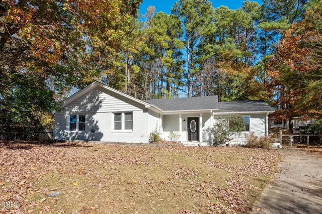 a front view of a house with a yard covered with snow